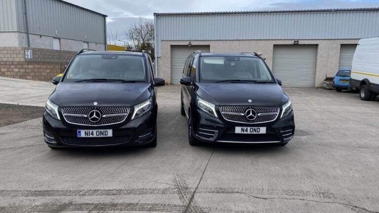 Two black Mercedes V-Class executive vehicles